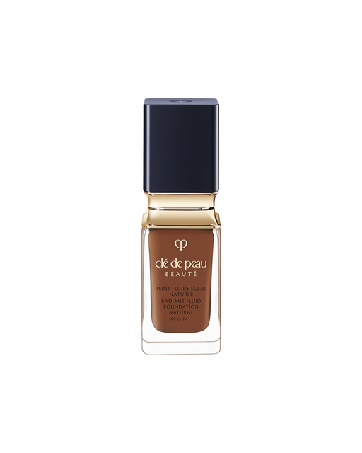 A bottle of Radiant Fluid Foundation Natural, a lightweight, long-lasting foundation with SPF 25. It has a square dark blue cap, gold collar, and clear glass bottle showing medium brown liquid foundation.